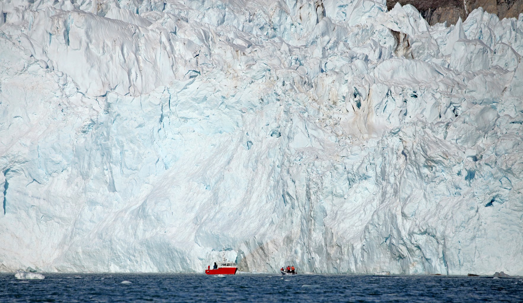 Isbreer på Svalbard med to små båter foran