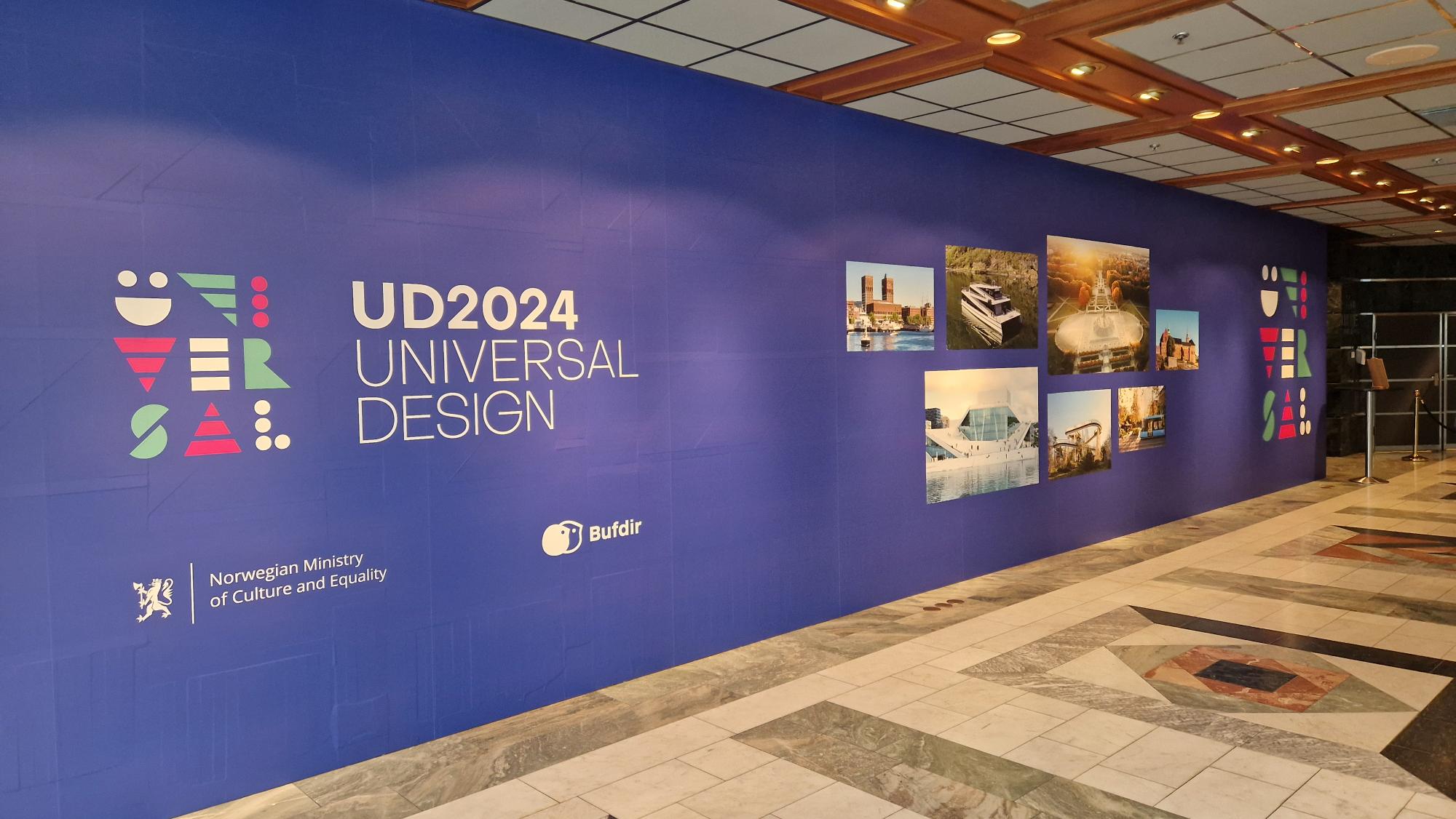 Gang med konferanselogo og bilder fra Oslo på blå vegg