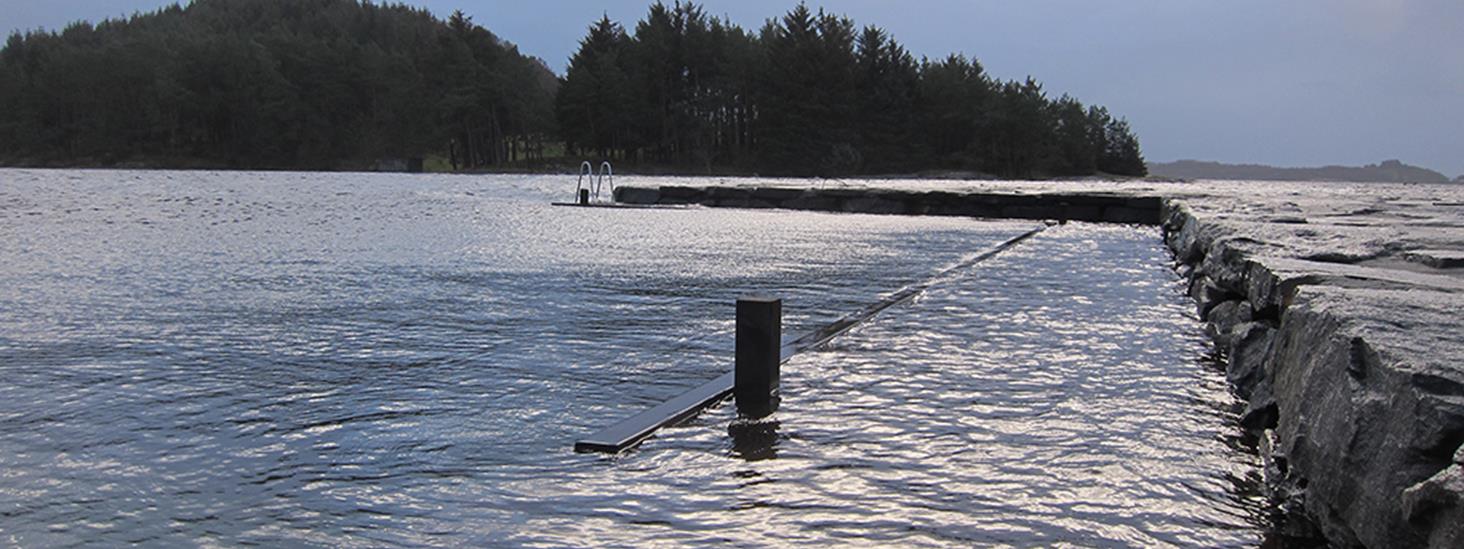 A pier being submerged underwater during a period of extra high water level. Photo